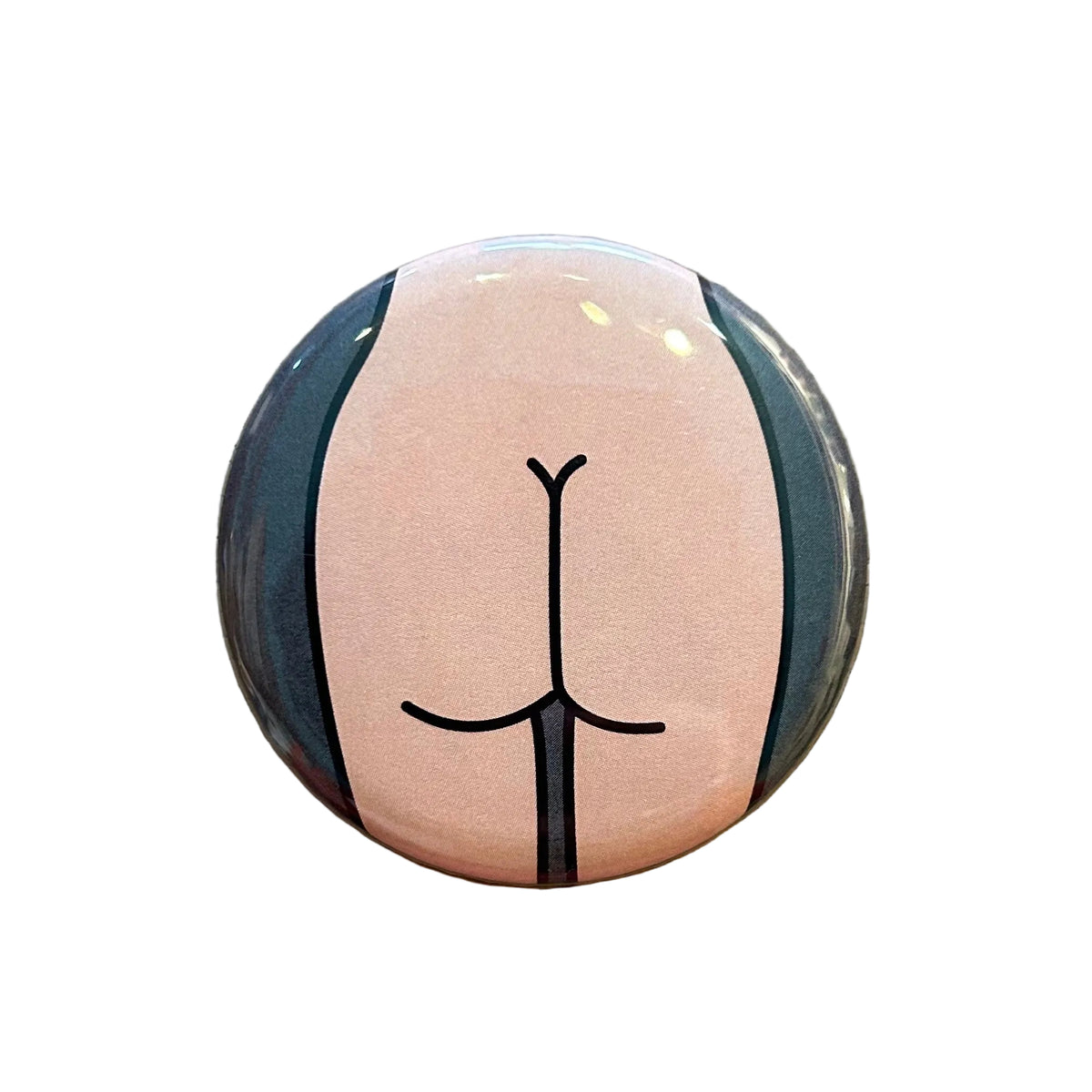 Round mirror with a cartoon illustration of a butt on the back