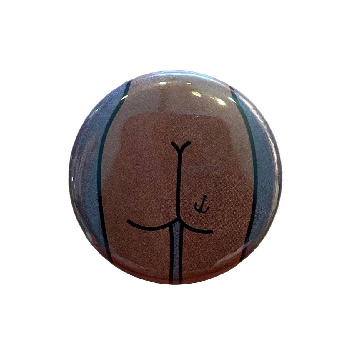 Round mirror with a cartoon illustration of a butt with an anchor tattoo on the back