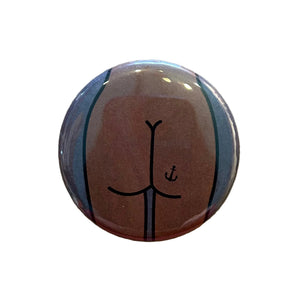 Round mirror with a cartoon illustration of a butt with an anchor tattoo on the back