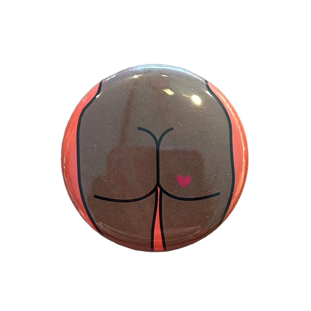 Round mirror with a cartoon illustration of a butt with a heart tattoo on the back