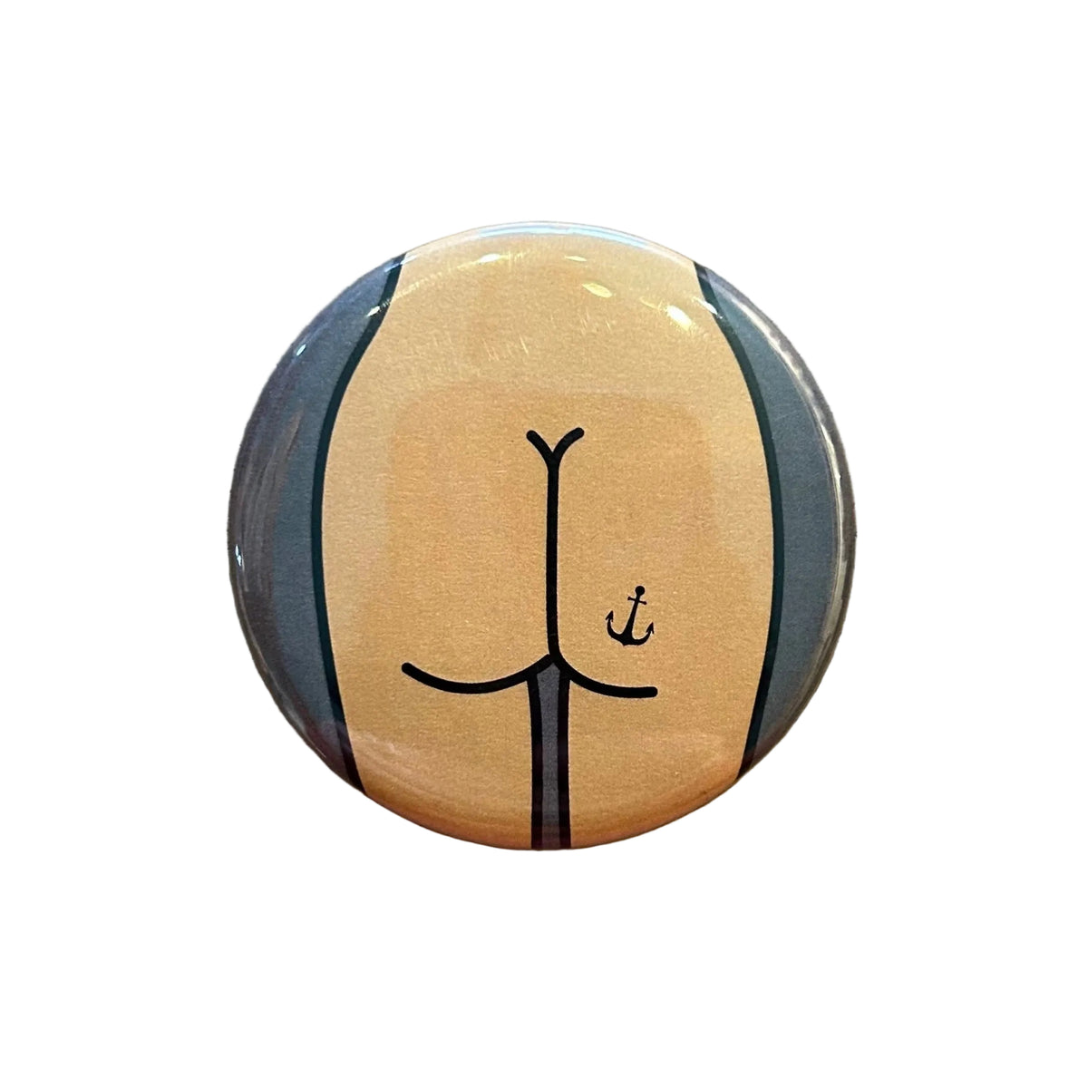 Round mirror with an illustration of a cartoon butt with an anchor tattoo on the back