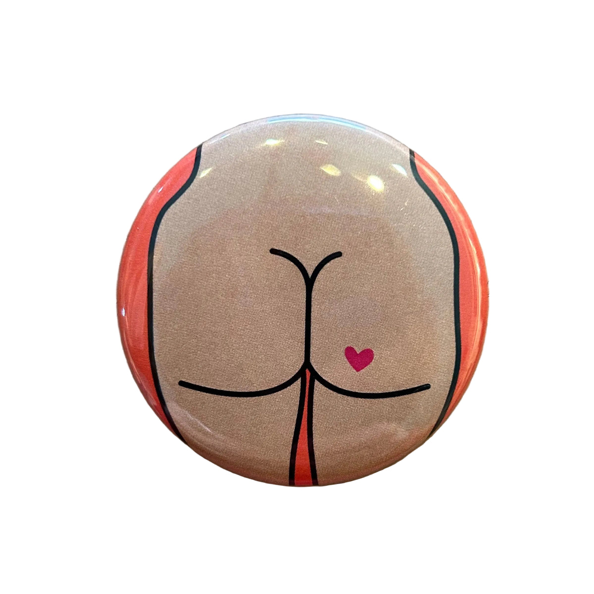 Round mirror with a cartoon illustration of a butt with a heart tattoo on the back