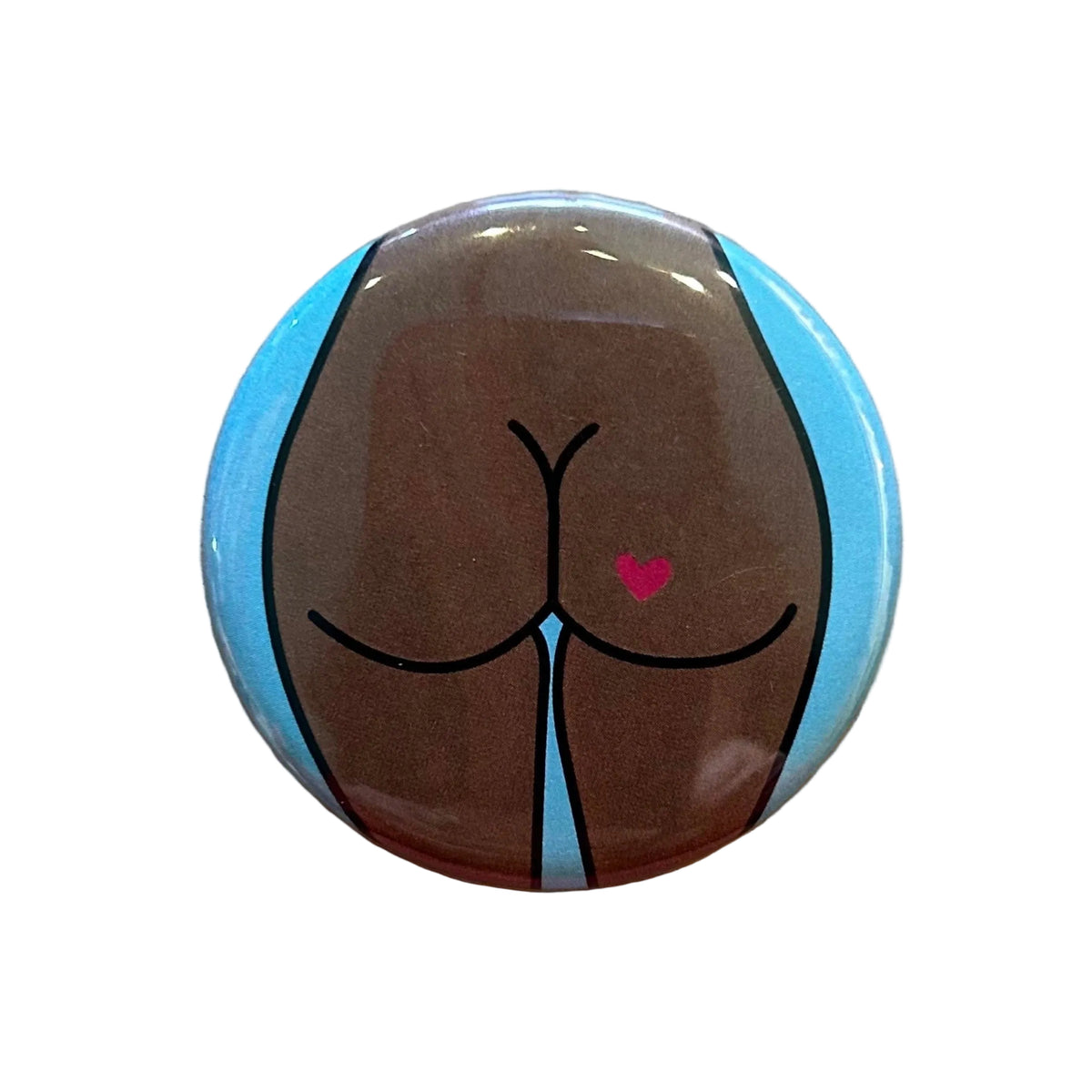Round mirror with a cartoon illustration of a butt with a heart tattoo on the back