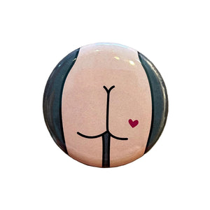 Round mirror with a design of a cartoon butt on the back