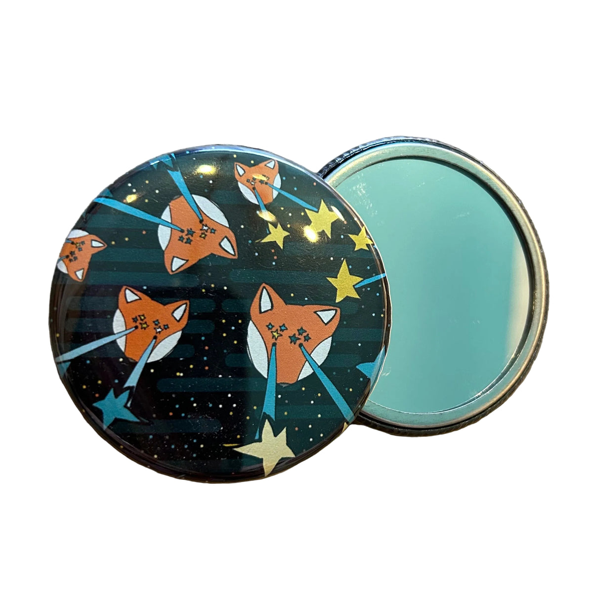 Small round mirror with illustrations of foxes shooting stars out of their eyes.