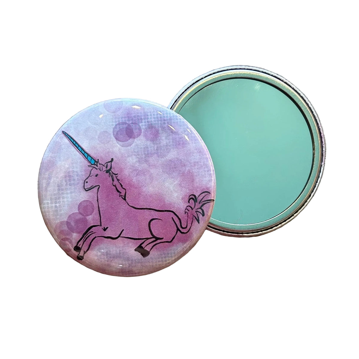 Round pink mirror with an illustration of a unicorn lying down. 