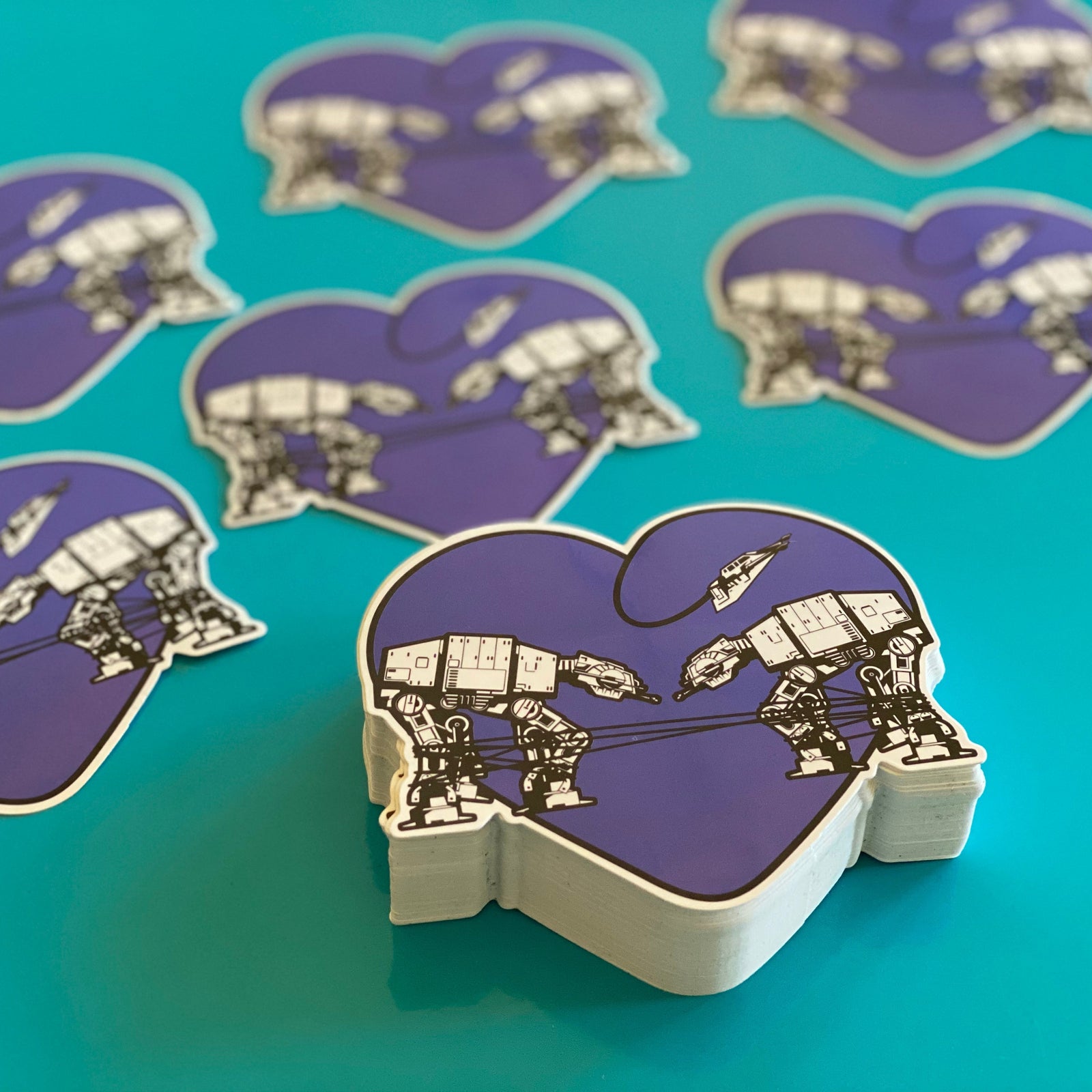 Purple and white heart shaped stickers on a teal background