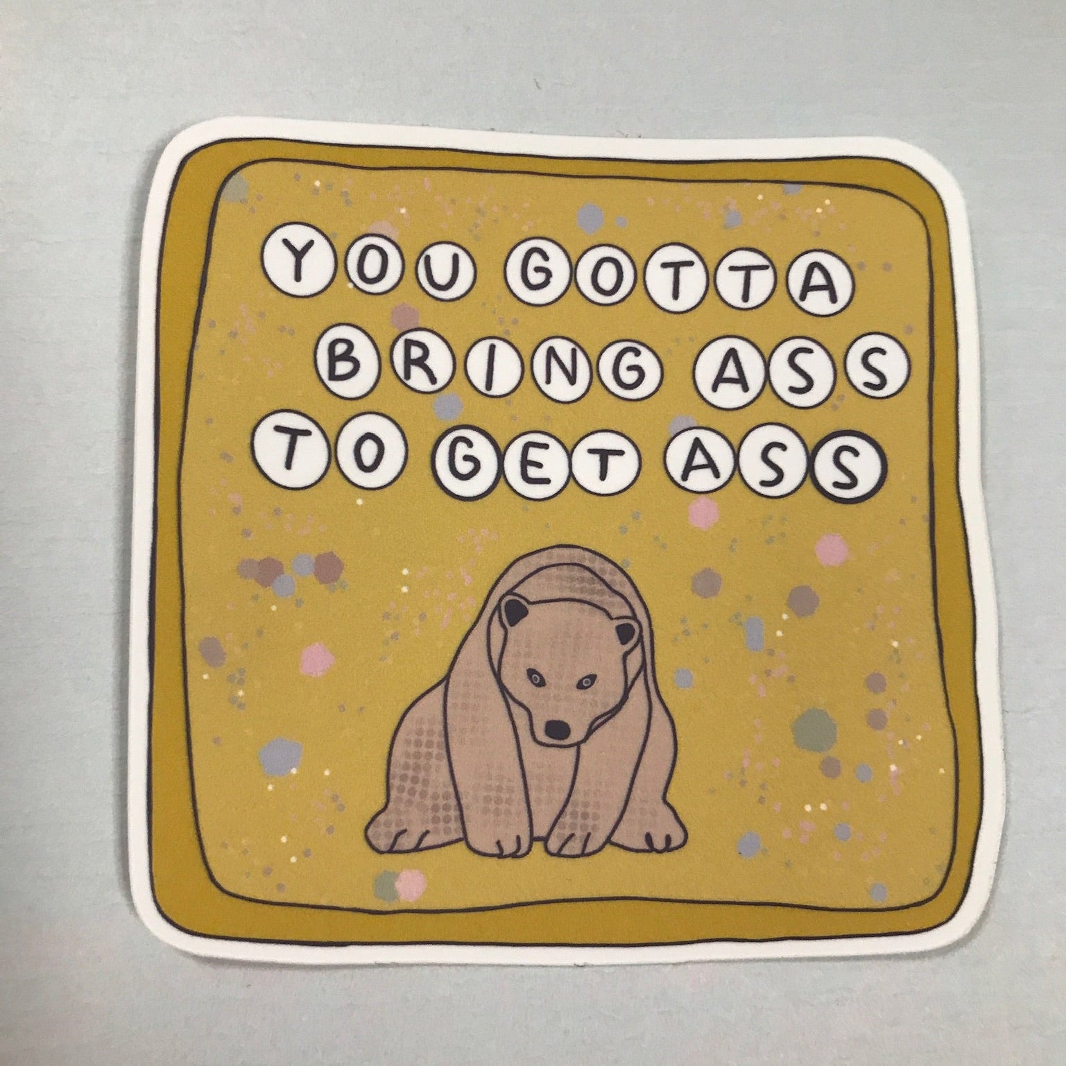 Sticker with bear illustration and text on a plain background