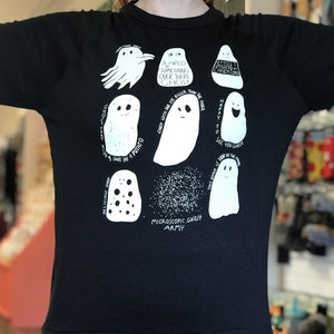 Black sweatshirt with white ghost illustrations worn by a person in a store setting. 