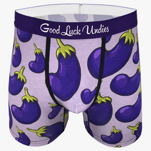 Boxer briefs with eggplant pattern and 'Good Luck Undies' waistband on a white background