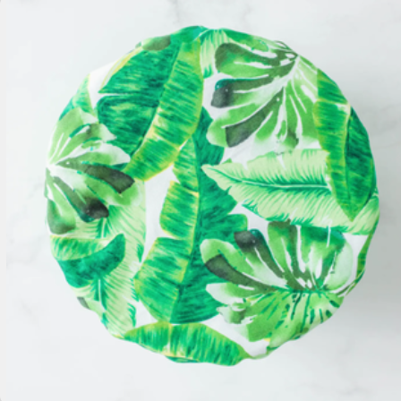 Green leaf-patterned bowl cover on a white background