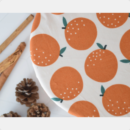 Fabric with orange fruit pattern on a white background