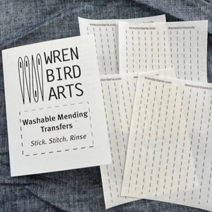 Wren Bird Arts washable mending transfers on a fabric background