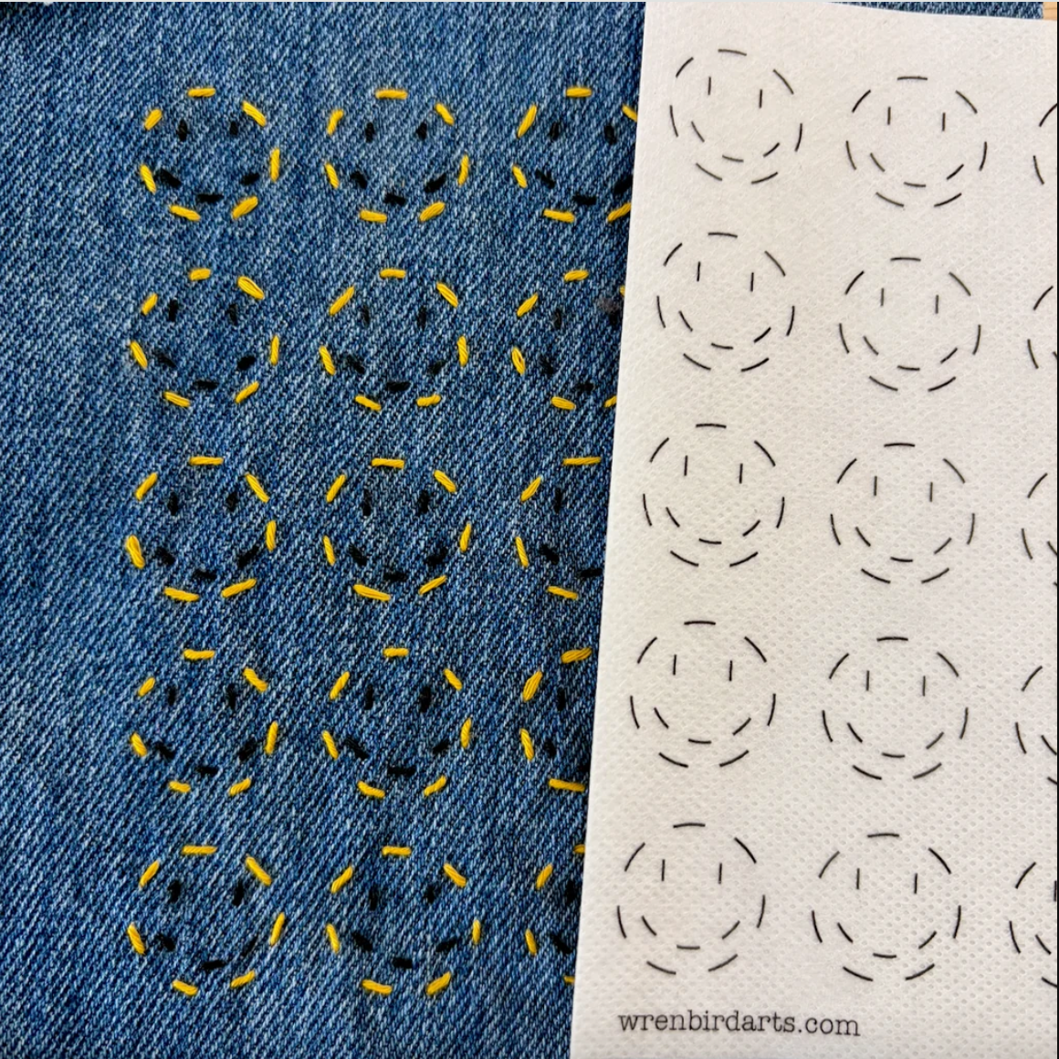 Stitched up example of smiley face mending transfer