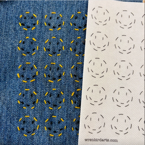Stitched up example of smiley face mending transfer