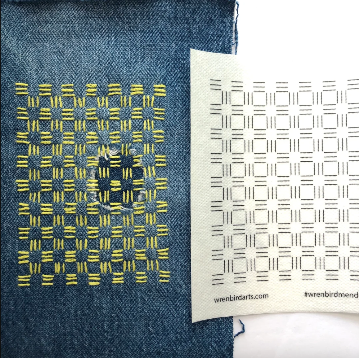 A close-up of a denim fabric sample with a yellow stitched grid pattern on the left, next to a white pattern card showing black stitched grid markings. The card has the website wrenbirdarts.