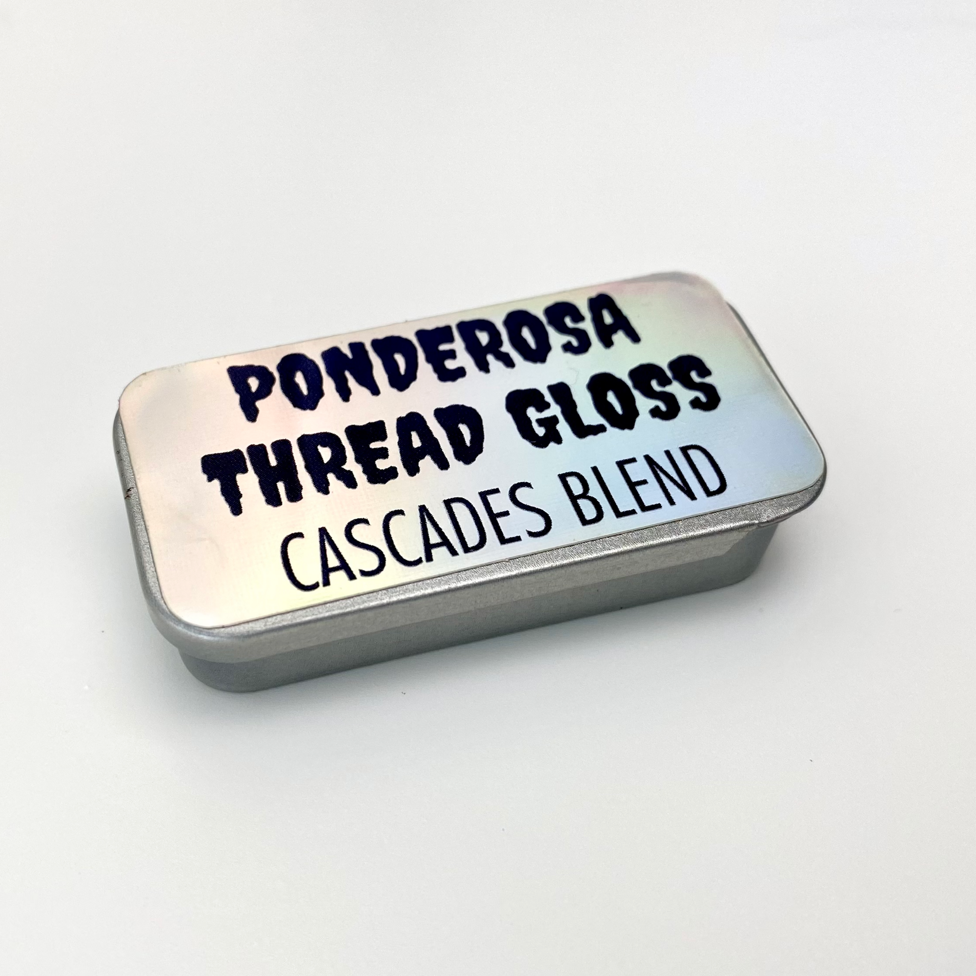 A tin of Ponderosa Thread Gloss - Cascades Blend - against a white background