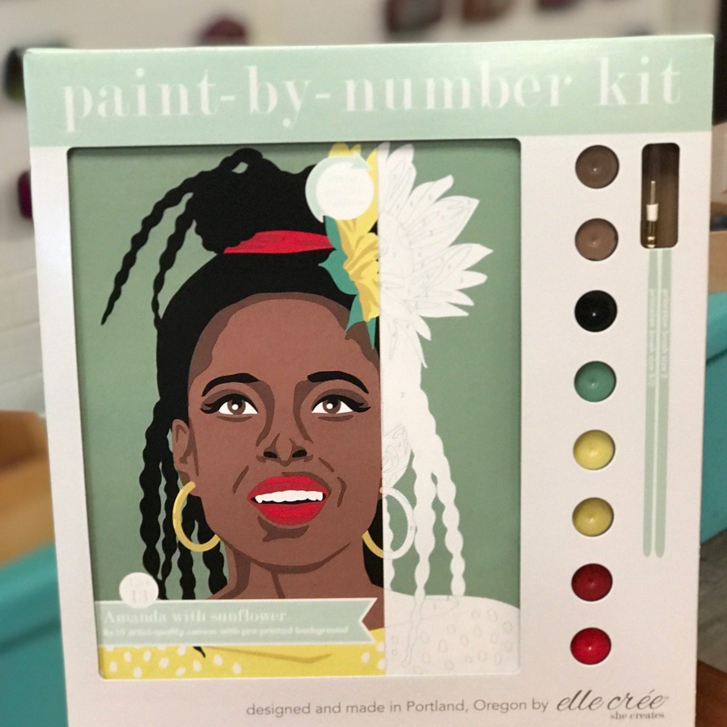 Paint by number kit by Elle Cree featuring Amanda Gorman, poet with yellow sunflowers in her hair.